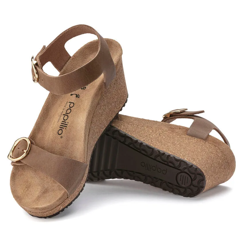 Certainly! Heres an optimized title for the product:

Birkenstock Papillio Soley Womens Wedge Sandals in Cognac Oiled Leather

This title includes key modifiers and details about the product.