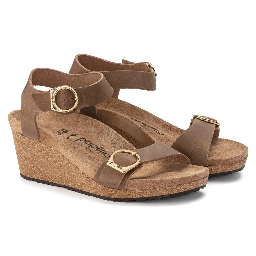 Certainly! Heres an optimized title for the product:

Birkenstock Papillio Soley Womens Wedge Sandals in Cognac Oiled Leather

This title includes key modifiers and details about the product.